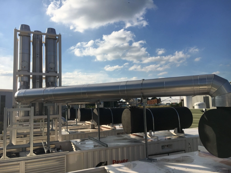 Containerized diesel generator being lowered onto its foundation by crane