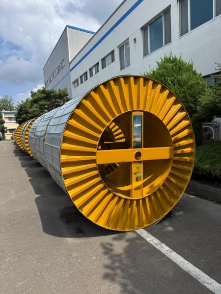 DC feeder cable reels staged between rows of solar trackers